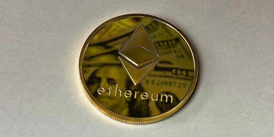 ethereum gold coin with a reflection of dollar bills on it